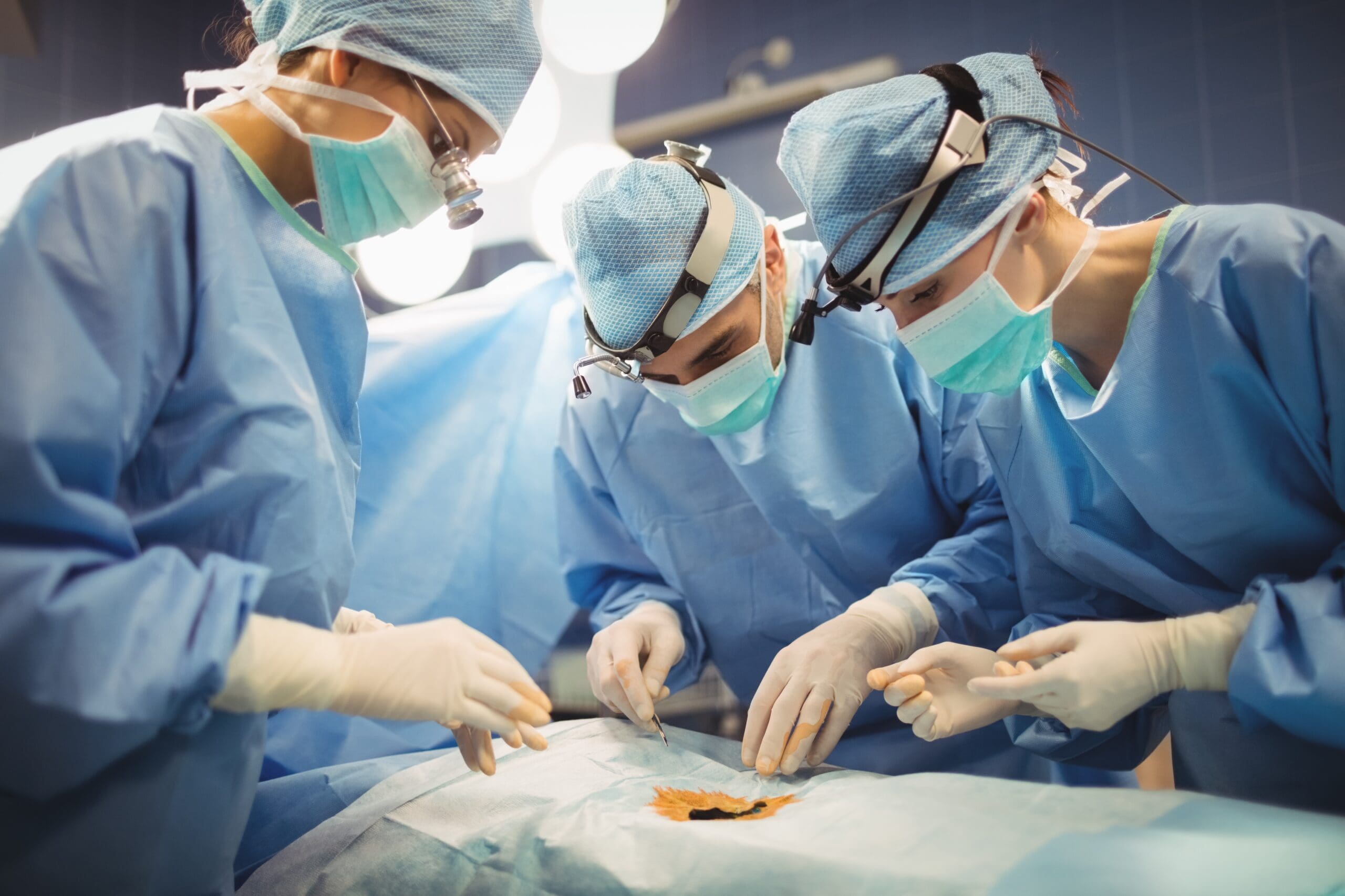 Surgeons performing operation in operation room